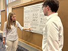 Maria and Tomas presenting at the undergraduate research poster session, August 2023